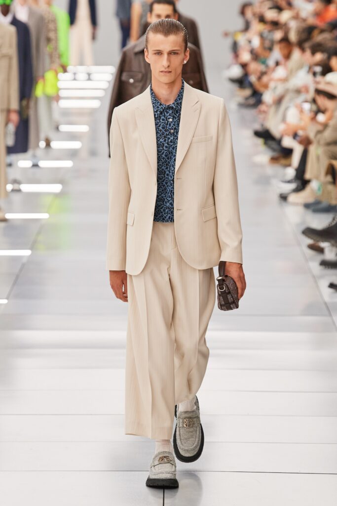 A relaxed beige suit featuring a collared long-sleeve shirt with a striped pattern.