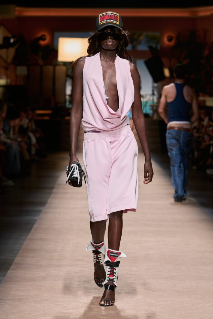 A relaxed pink sleeveless dress with a deep V-neckline and draped design.