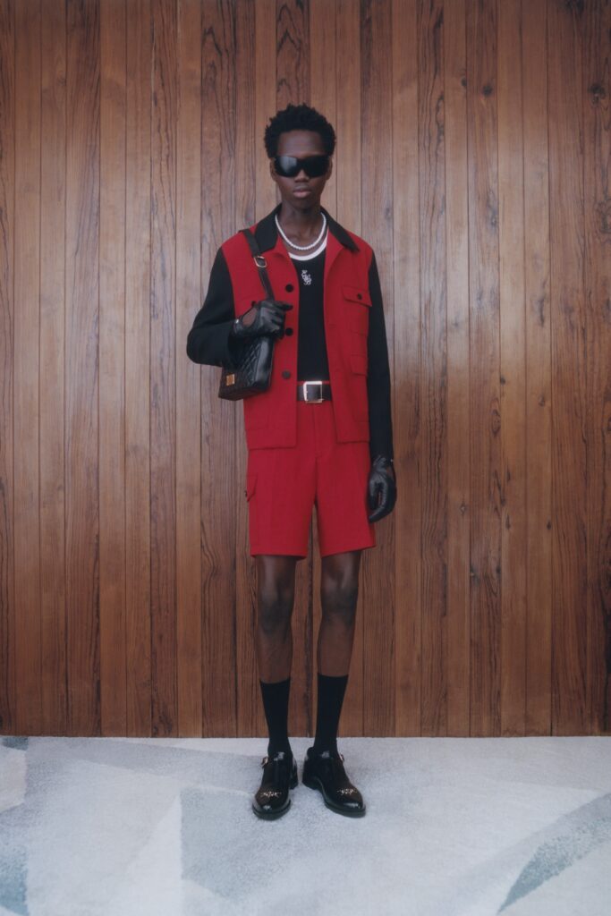 A fitted red and black short-sleeve jacket paired with matching shorts, showcasing a color-blocked design.
