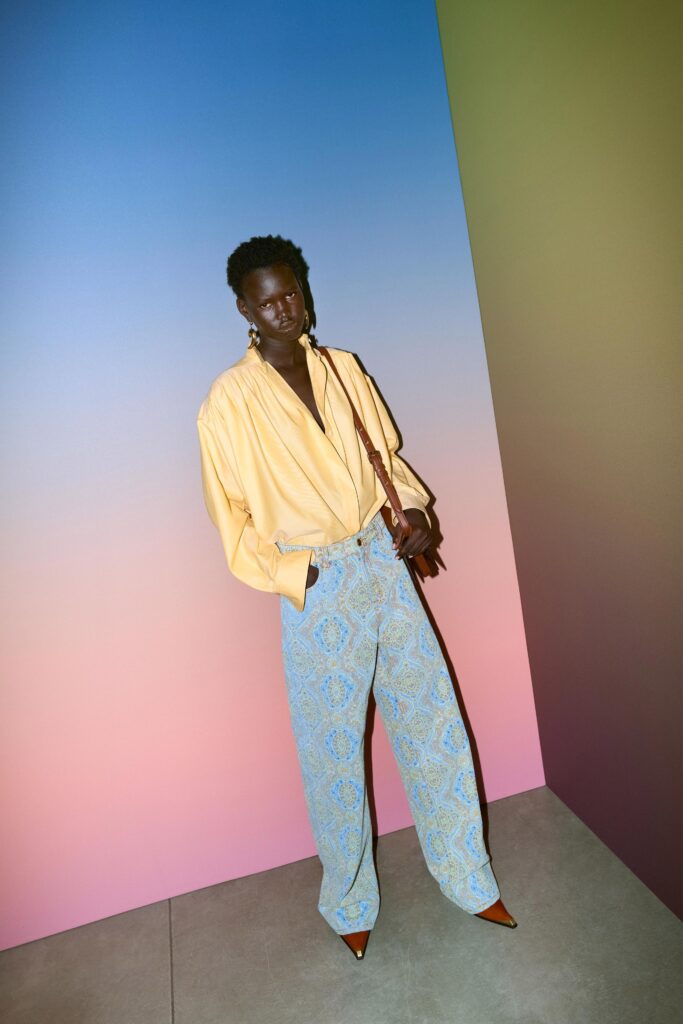 A relaxed yellow collared shirt paired with printed wide-leg blue pants.
