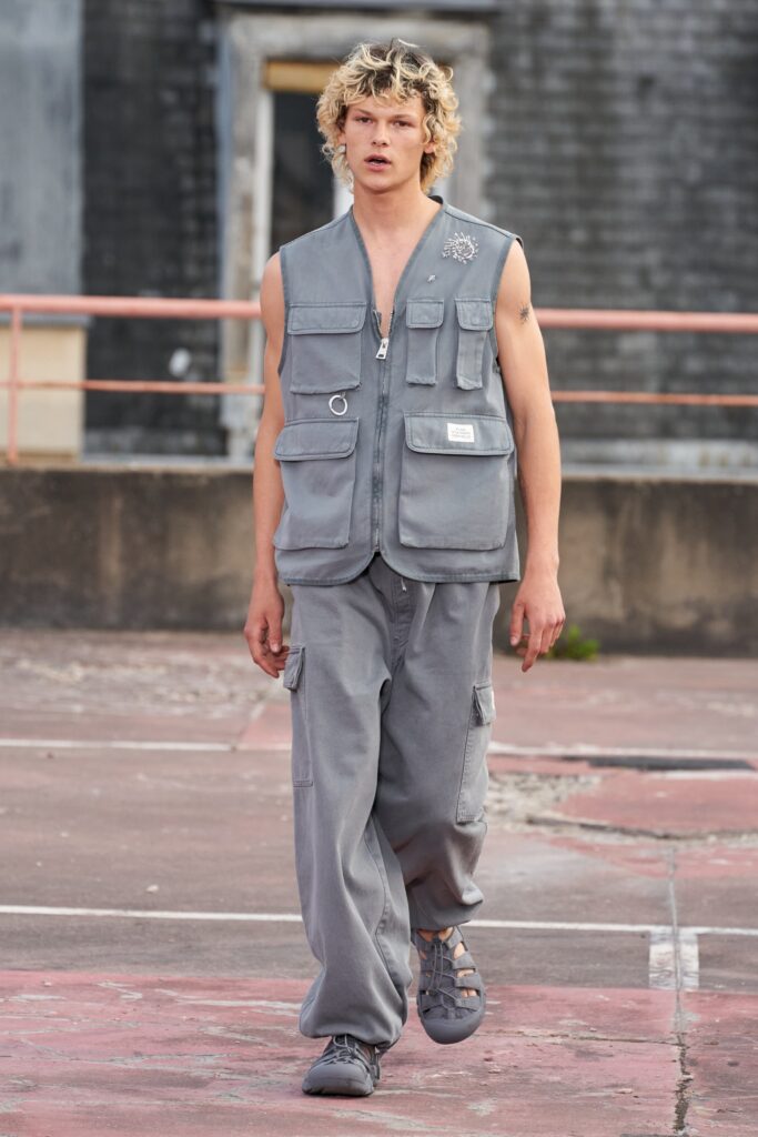 A relaxed gray cargo vest paired with matching pants, showcasing a modern streetwear style.