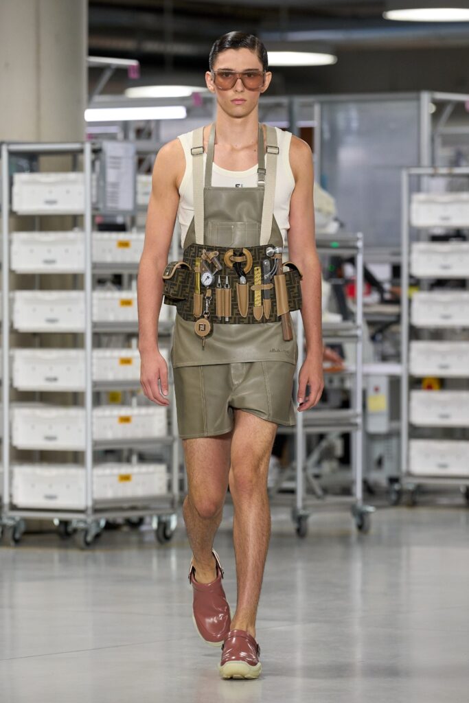 A fitted beige leather sleeveless dress with a collared design and straight-leg silhouette.