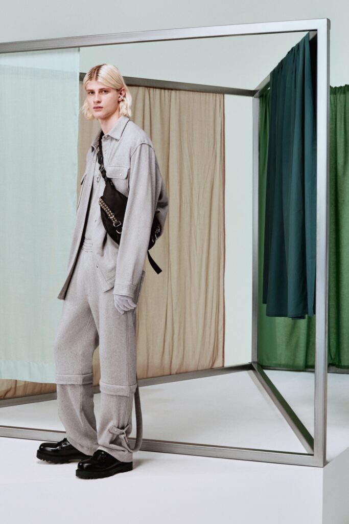 A relaxed gray jacket with long sleeves and collared design paired with straight-leg pants.