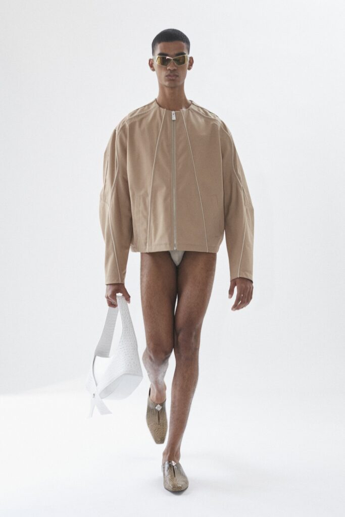 An oversized beige cotton jacket with long sleeves and a zippered front.