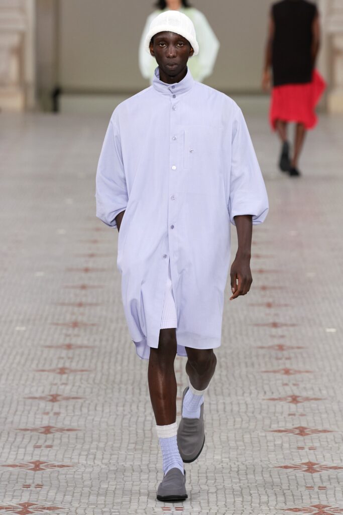 A relaxed blue cotton shirt-dress with short sleeves and a buttoned front.