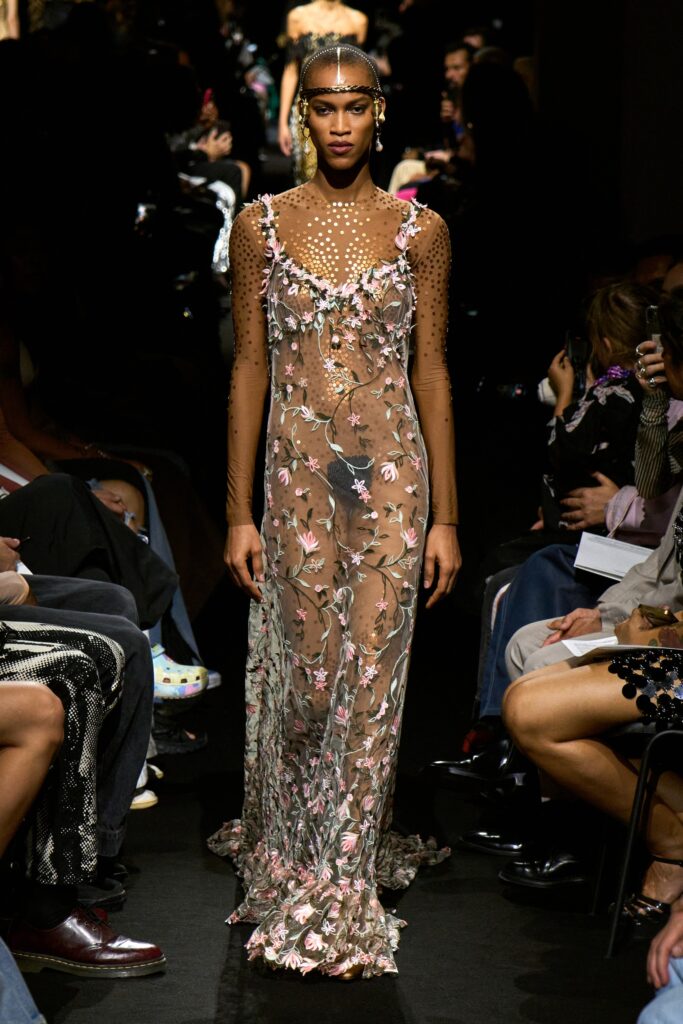 A fitted multicolor lace sleeveless dress with a V-neckline and floral sheer design.