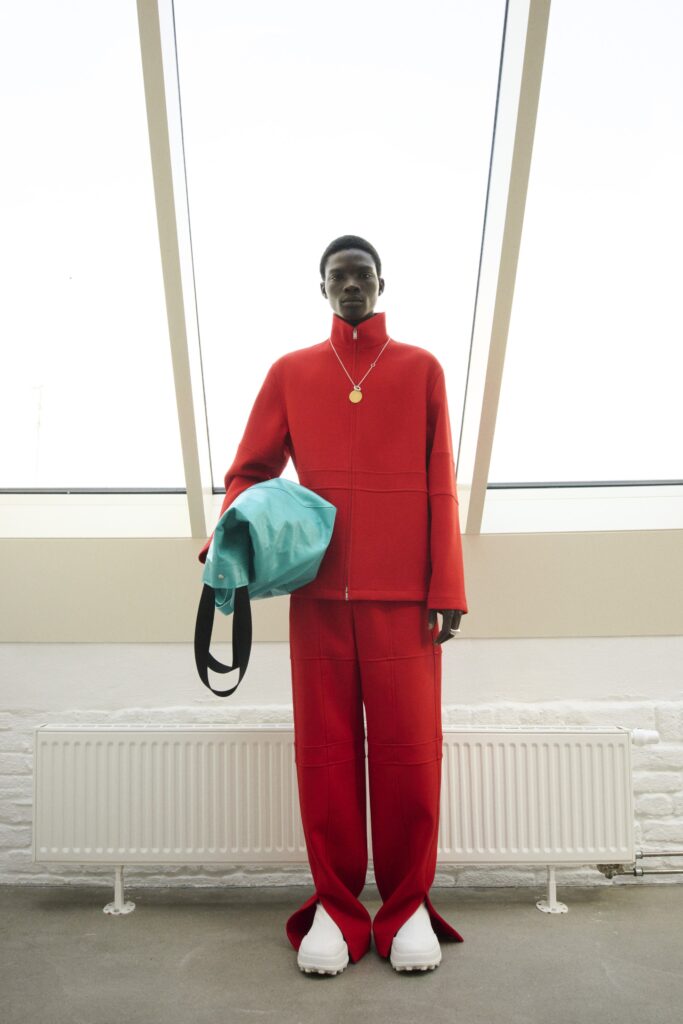 An oversized red jacket with zippered closure paired with matching red pants.