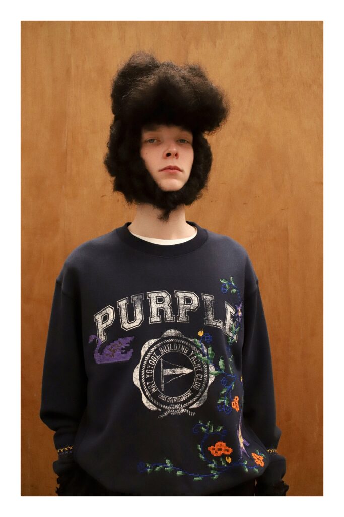 A purple cotton long-sleeve sweater featuring intricate embroidery and a relaxed fit.