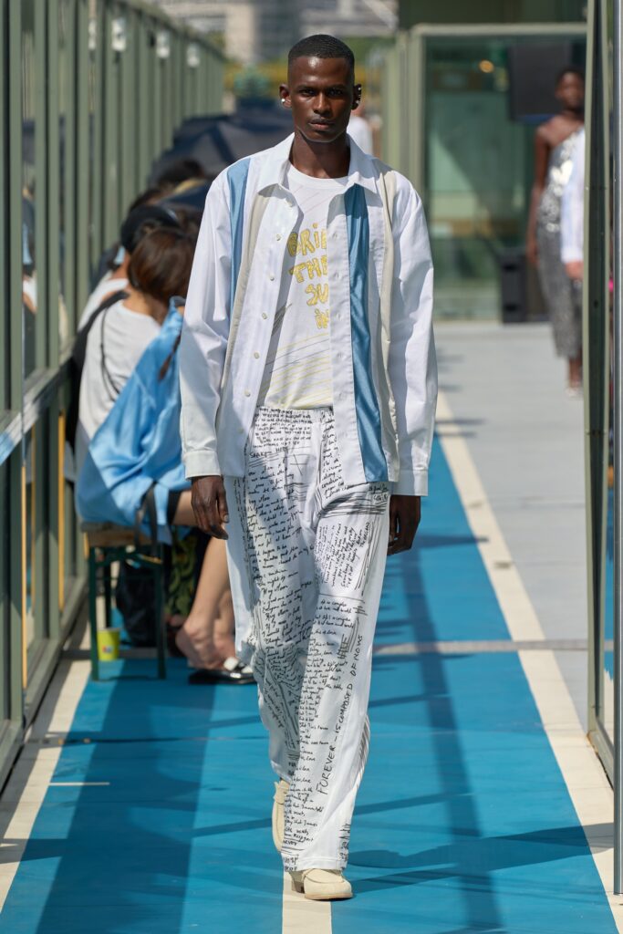 A relaxed white long-sleeve collared shirt paired with printed cotton pants.