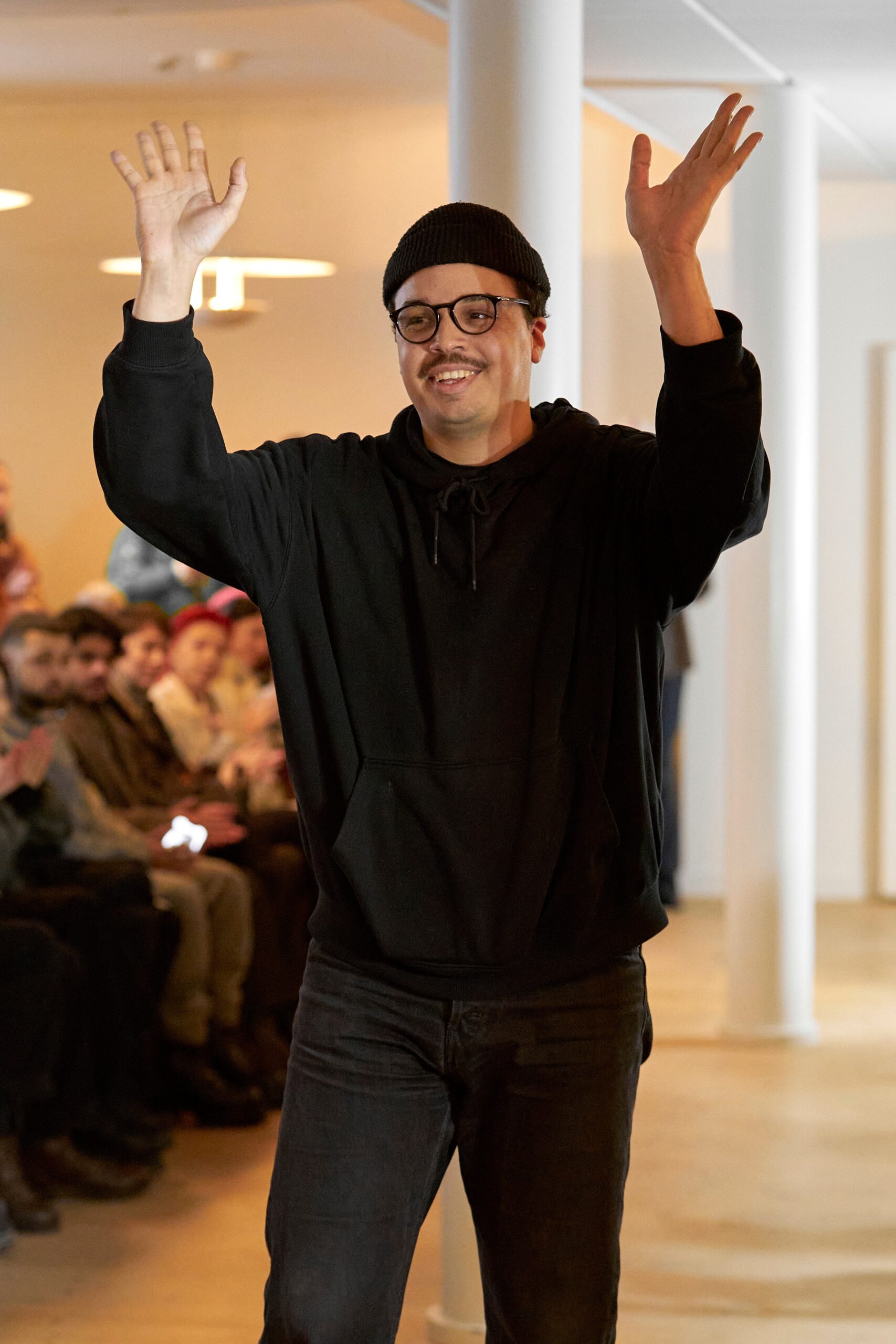 A relaxed black cotton hoodie paired with matching pants, perfect for casual wear.
