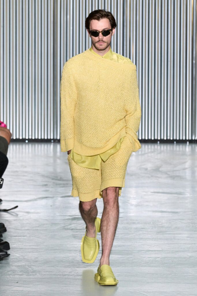 A relaxed yellow cotton sweater paired with matching shorts, featuring a textured design.