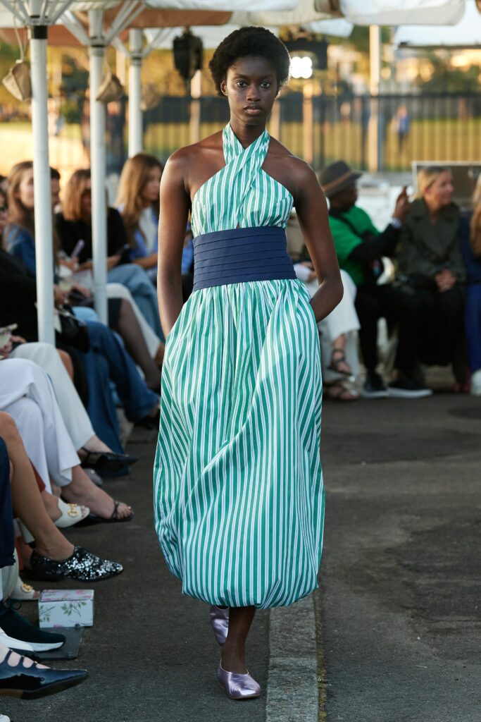 A relaxed green and white striped dress with a halter neckline and tiered design.
