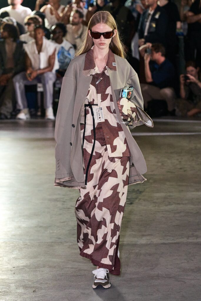 A relaxed brown and cream printed dress with long sleeves and a collared neckline.