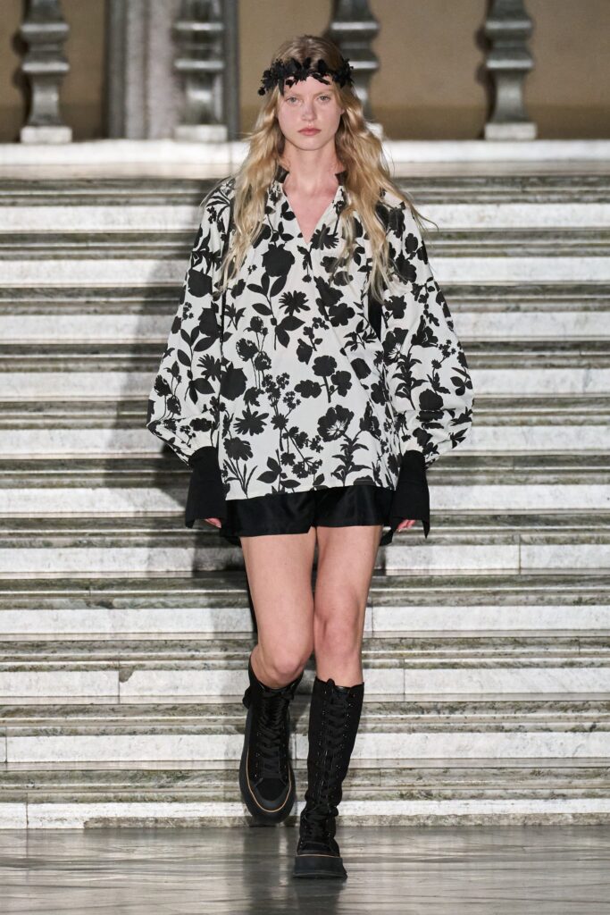 A relaxed black and white floral shirt with long sleeves paired with matching shorts.