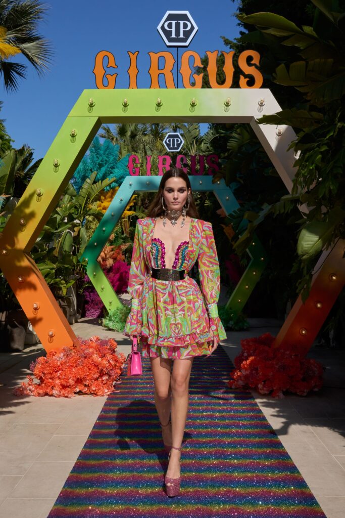 A fitted multicolor dress with long sleeves and a V-neckline featuring a flared silhouette.