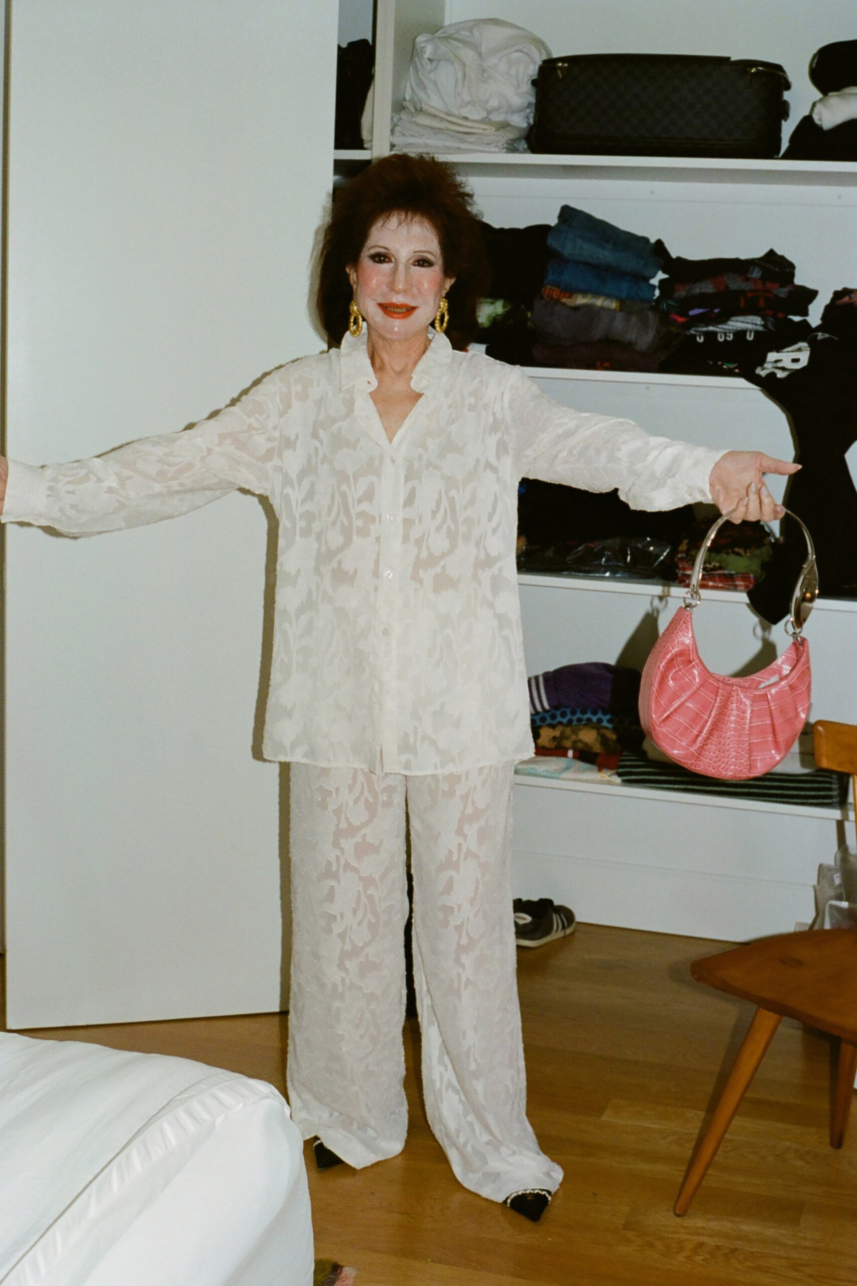 A relaxed white silk shirt with long sleeves and a collared neckline paired with matching printed pants.