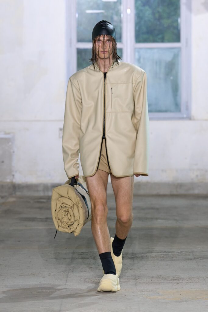 An oversized beige neoprene jacket with long sleeves and a zippered front.