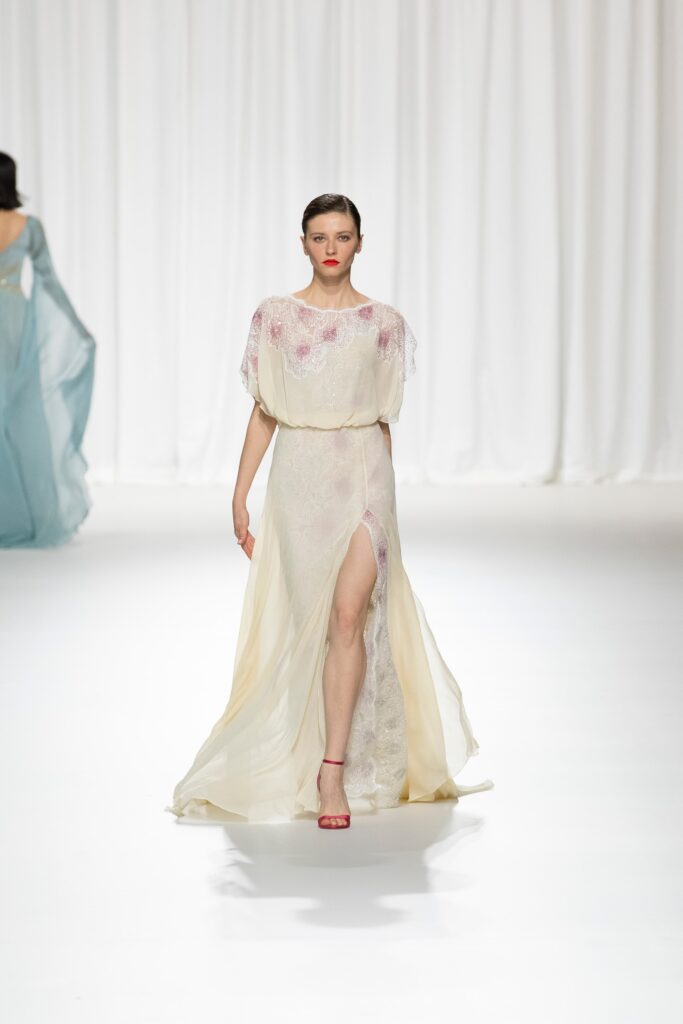 A relaxed cream silk sleeveless dress with a V-neckline and a stylish slit.