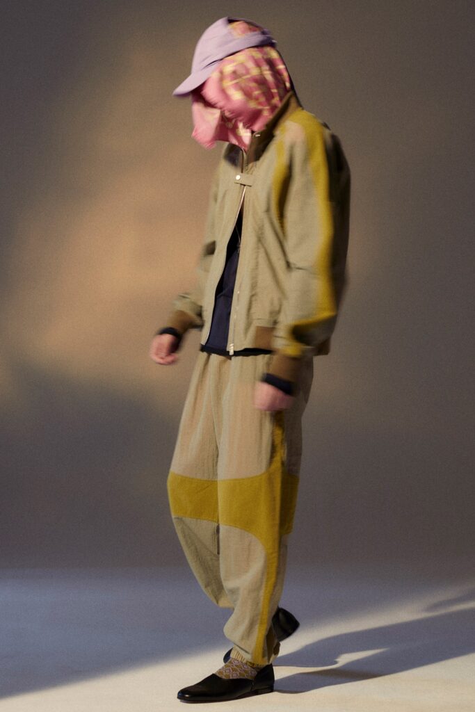 A relaxed beige cotton jacket with color-blocked details paired with matching pants.