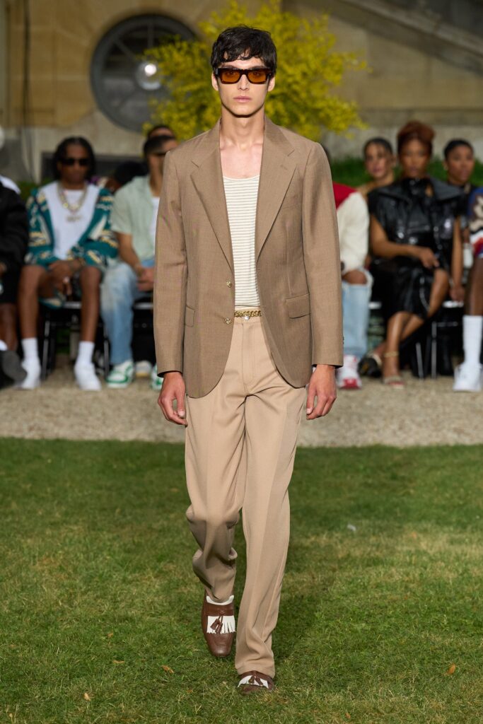 A tailored brown suit with a collared long-sleeve shirt and straight-leg pants.