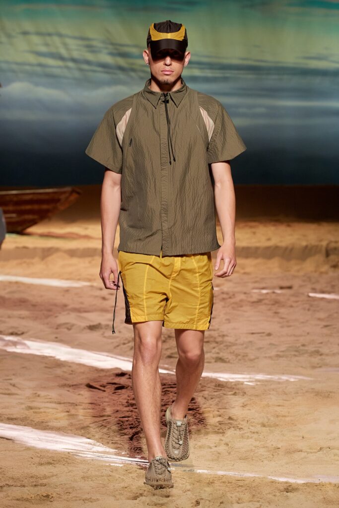 A relaxed green cotton short-sleeve shirt paired with yellow shorts featuring a zippered detail.
