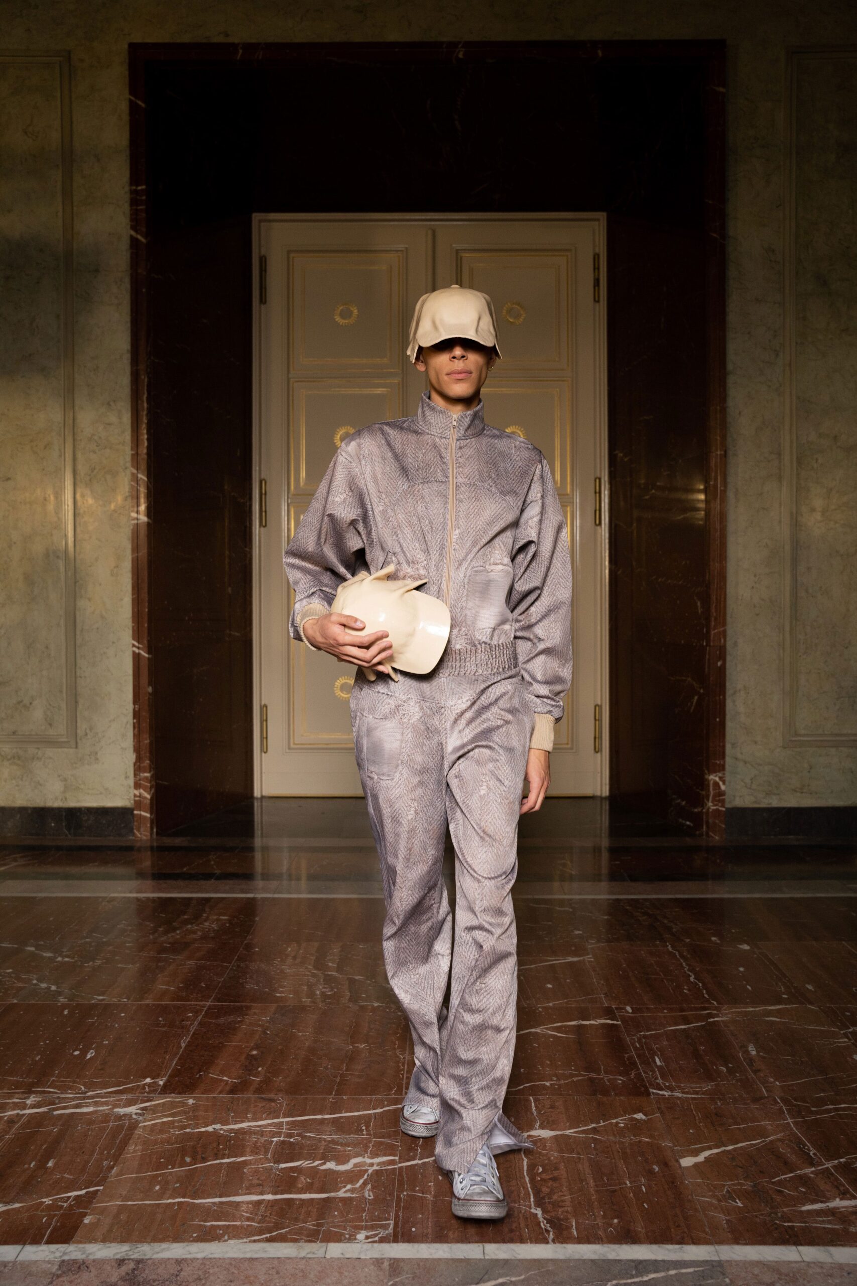A relaxed gray cotton jacket with long sleeves and matching pants featuring a zippered detail.