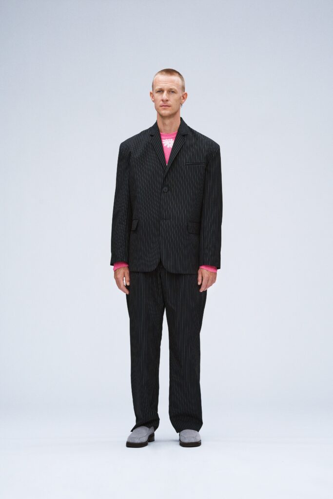 black striped tailored suit with pink sweater