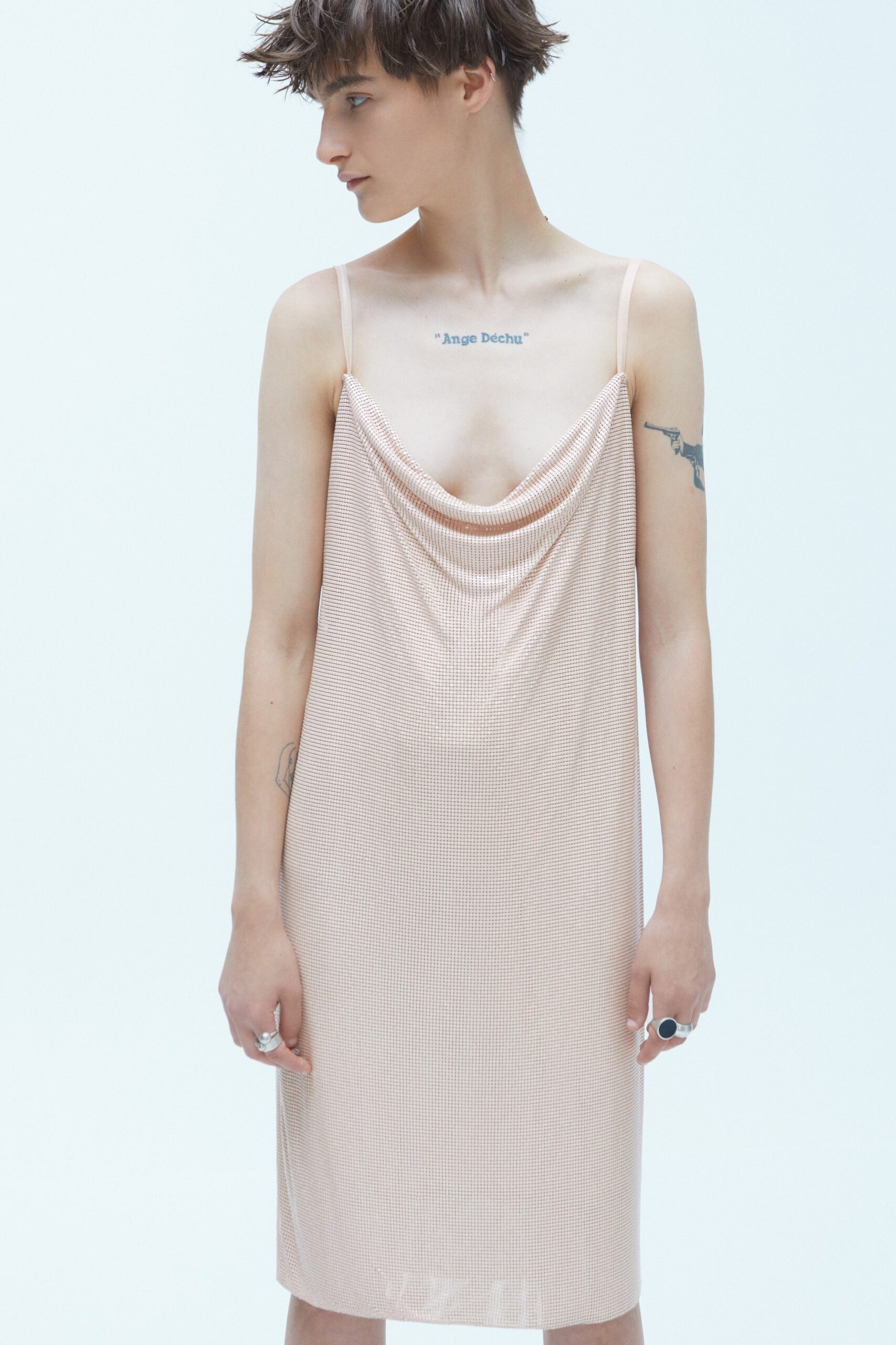 A relaxed pink silk sleeveless dress with a draped V-neckline.