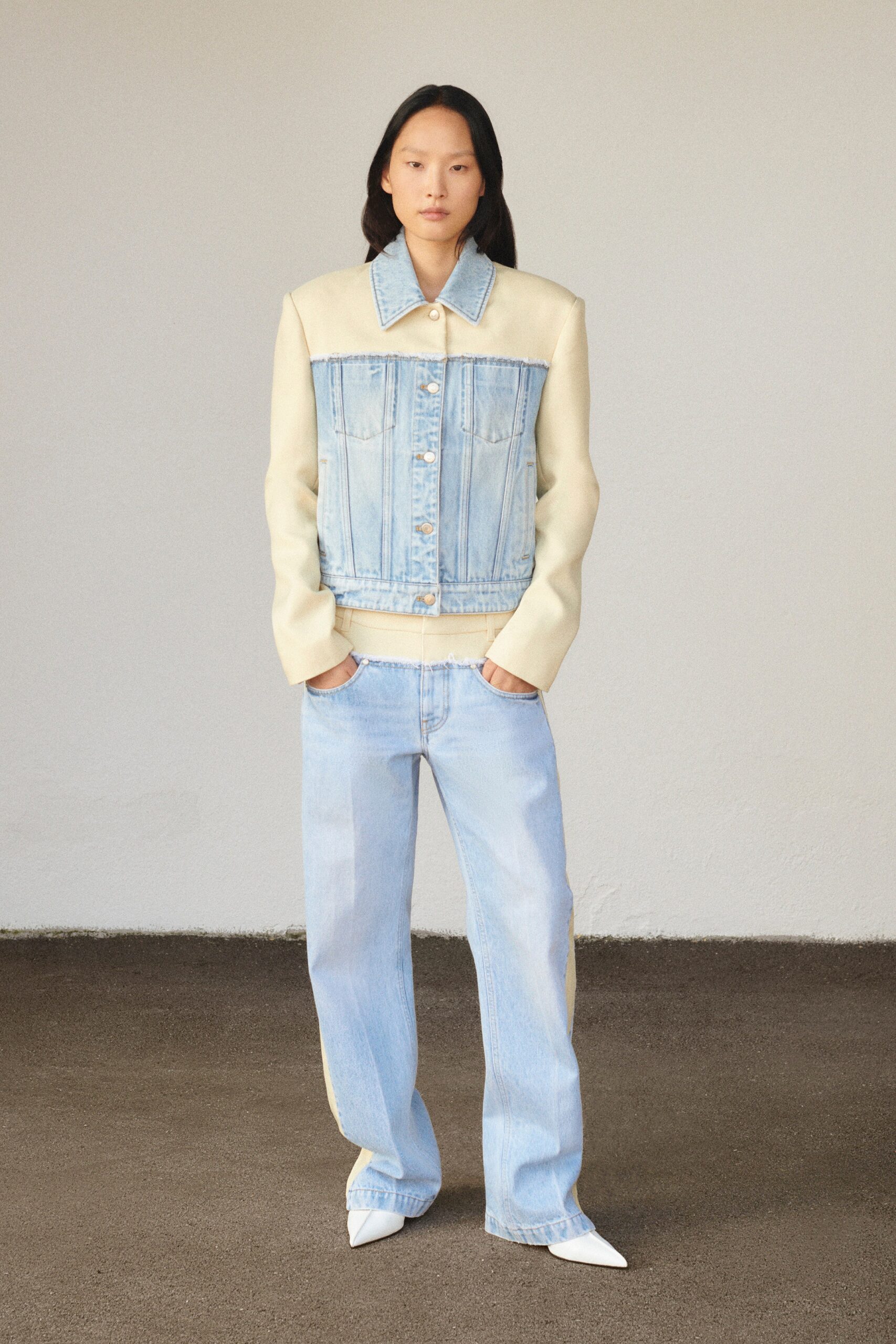 A relaxed cream denim jacket paired with wide-leg blue pants, featuring a collared design.