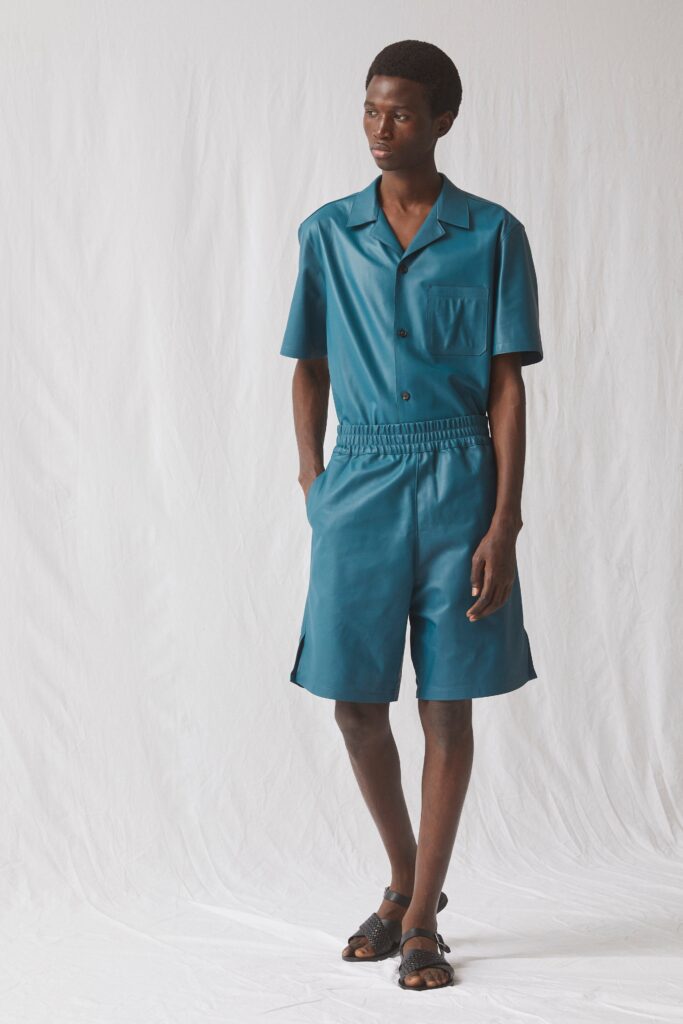 A relaxed blue leather short-sleeve shirt paired with matching shorts featuring a buttoned design.