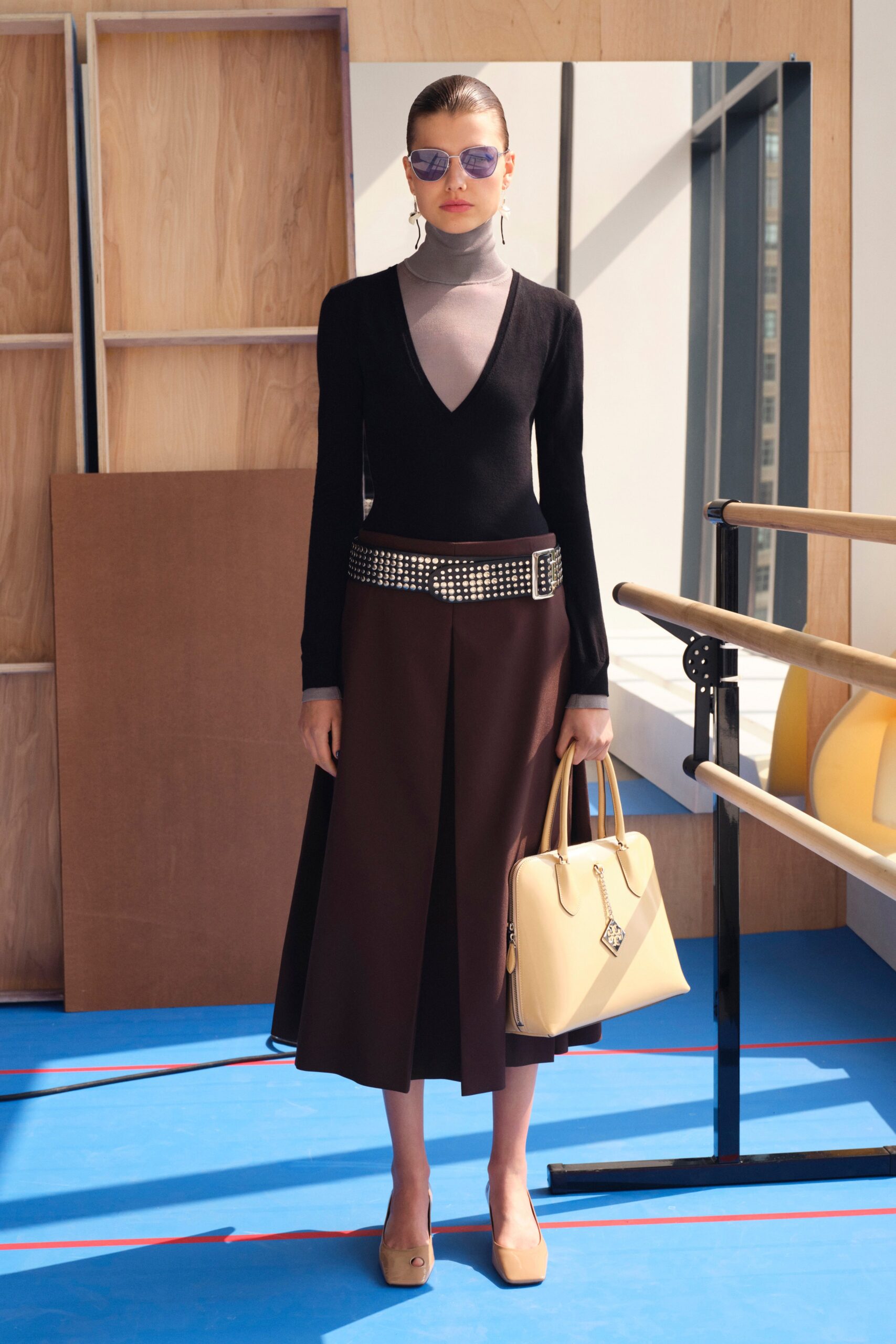 A fitted black and brown dress with a V-neckline and A-line silhouette.