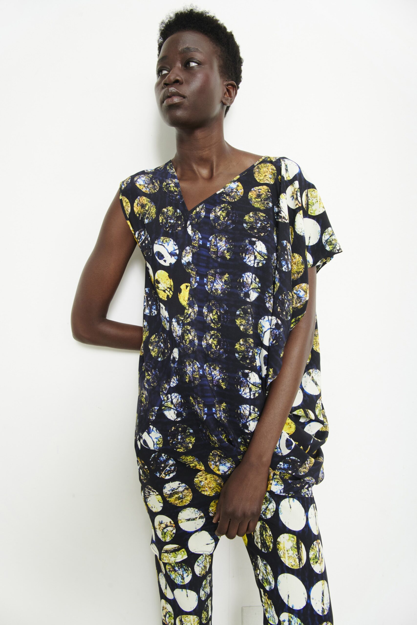 A relaxed fit top with a V-neck and short sleeves, paired with printed pants.