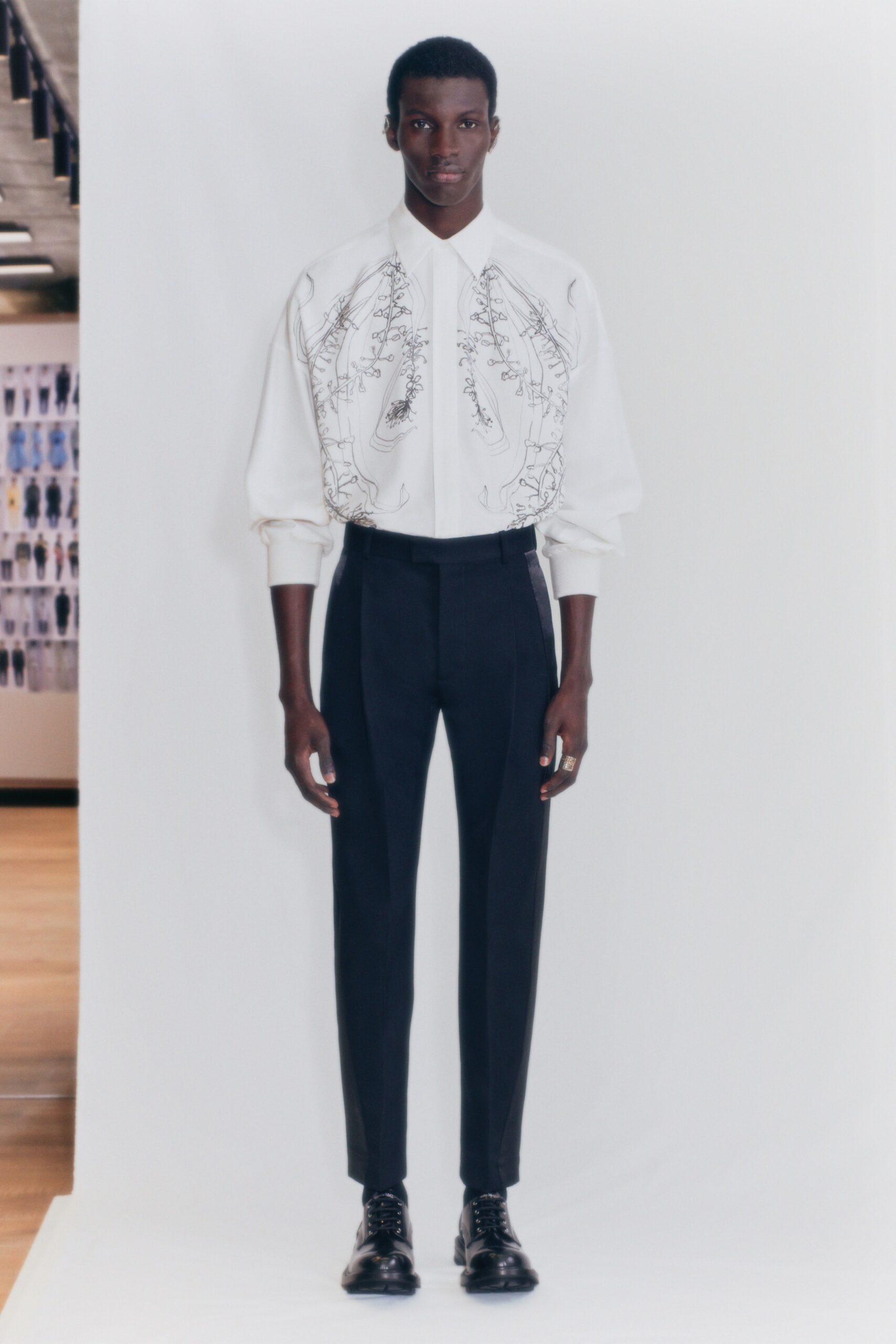 white embroidered shirt and black tailored pants