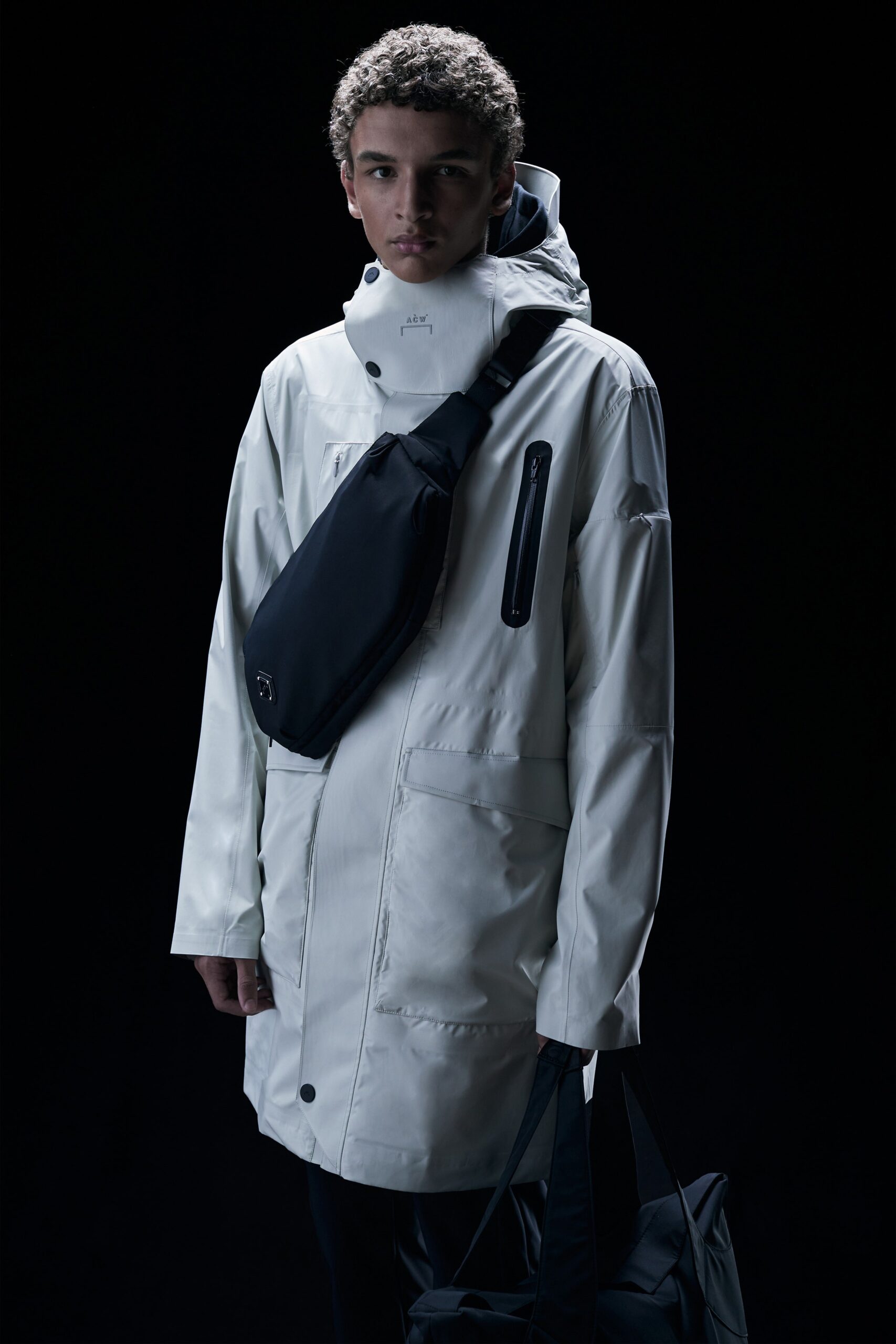 This parka features a relaxed silhouette, designed with a functional hood and long sleeves for versatility. The zippered details enhance its contemporary appeal, making it a striking outerwear choice that balances practicality with modern aesthetics.
