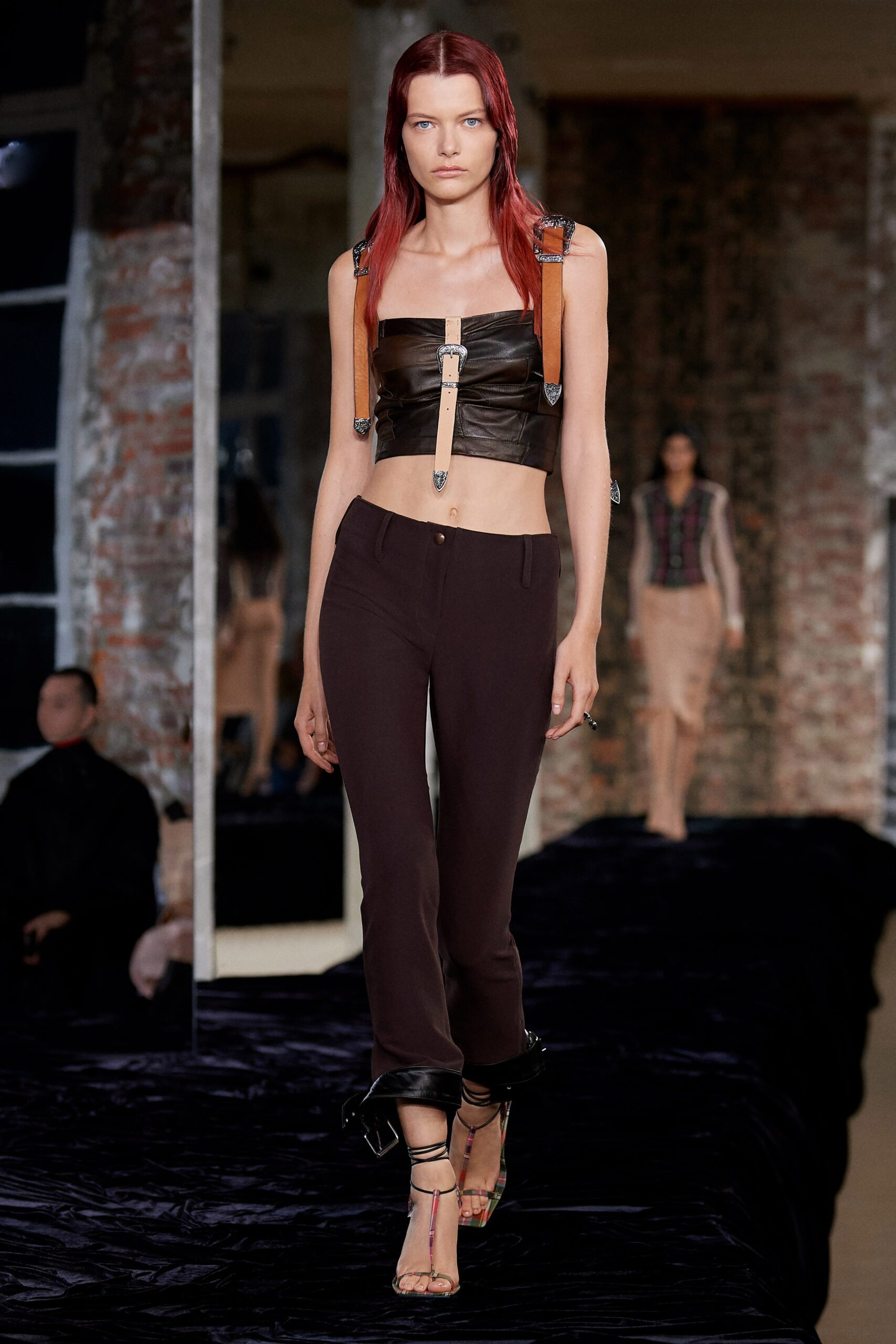 black leather crop-top with brown pants