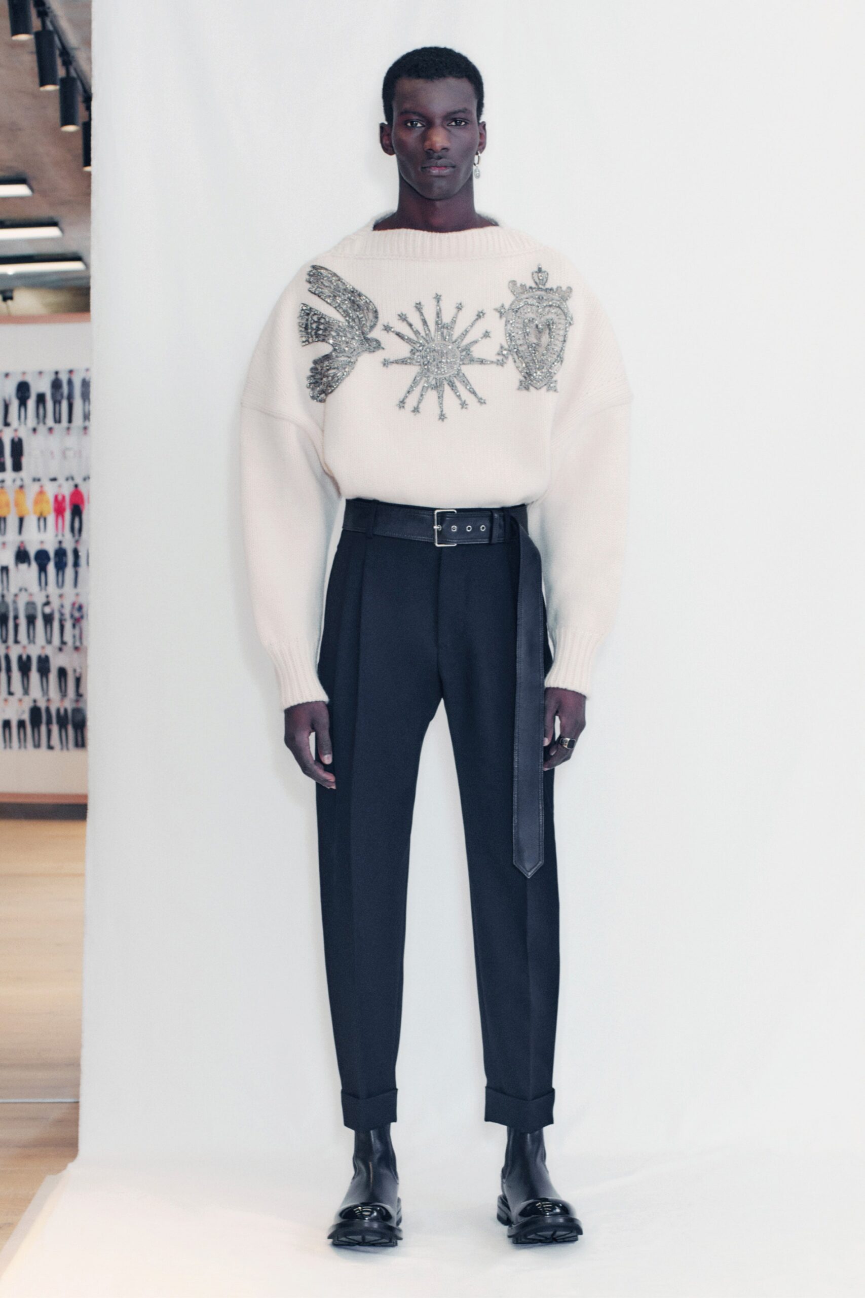 beige embroidered sweater and black tailored pants
