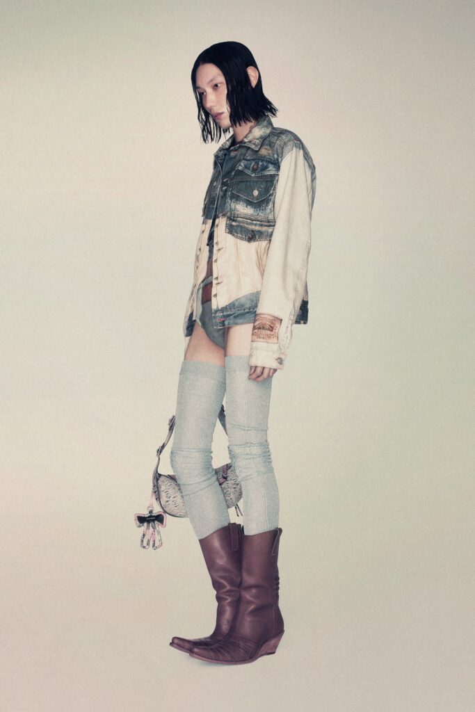 A fitted blue denim jacket paired with gray cotton pants featuring a distressed look.
