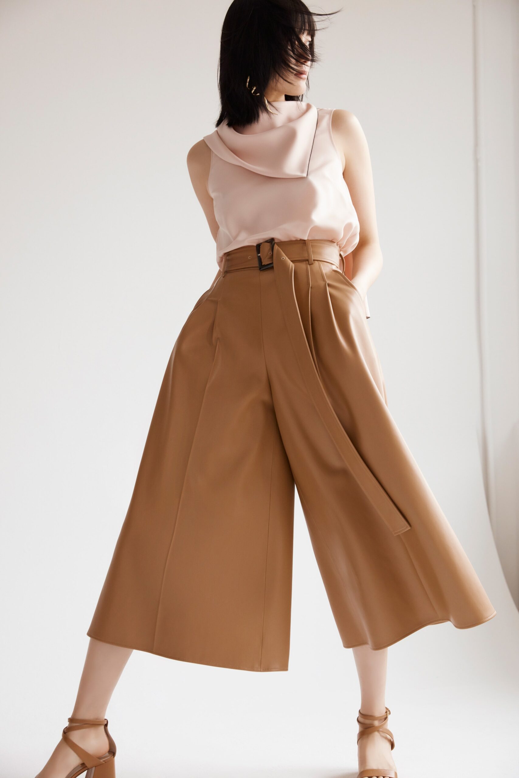 pink silk sleeveless top with brown leather pants