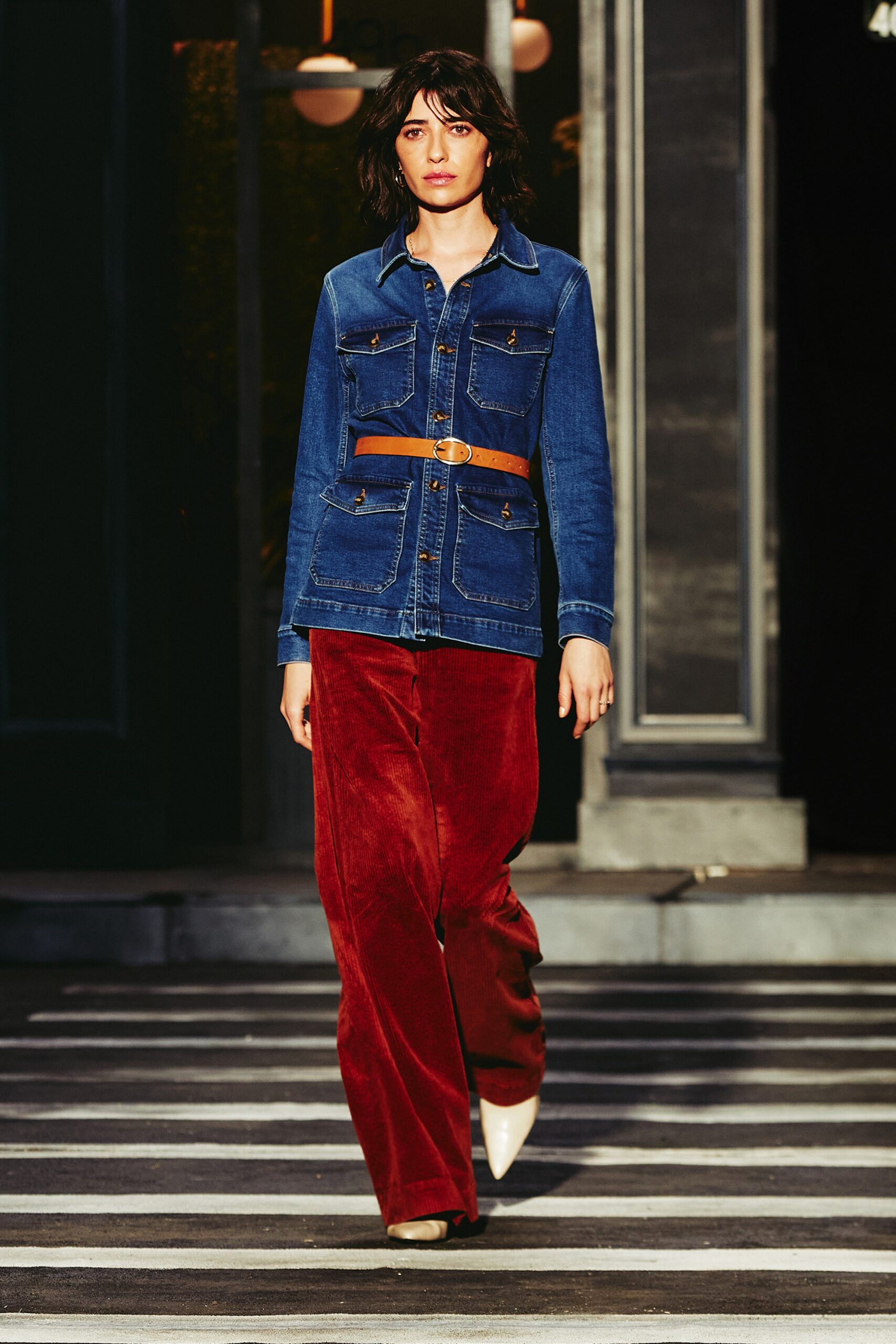A relaxed blue denim jacket paired with wide-leg red velvet pants.