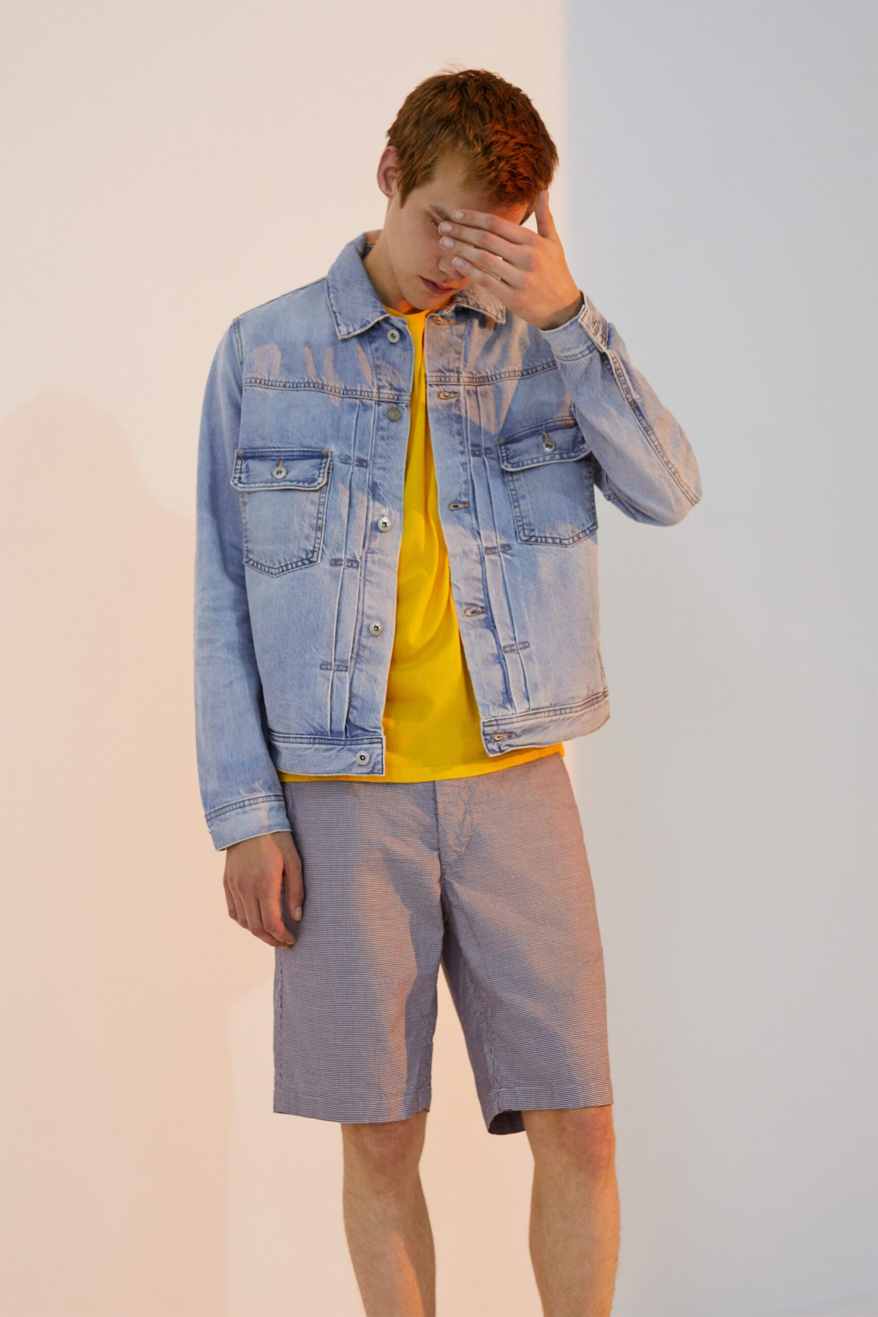 blue denim jacket with yellow t-shirt and gray shorts