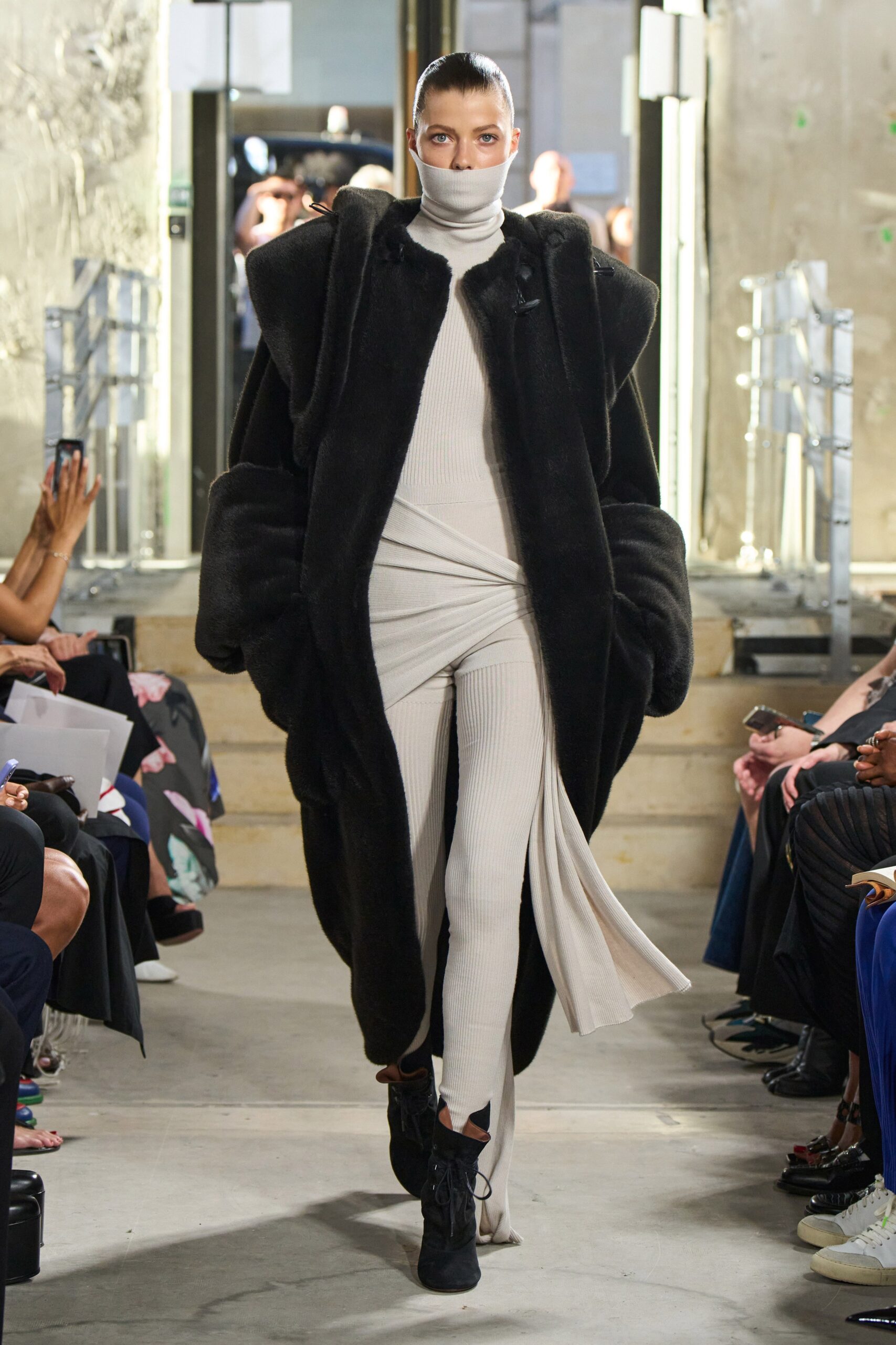 black faux-fur coat and white dress