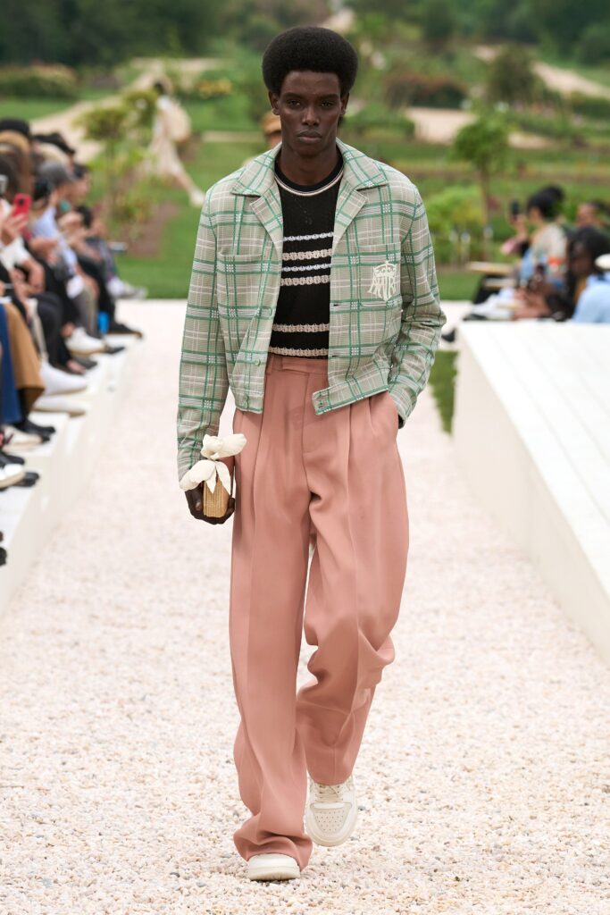 A relaxed-fit green checked jacket paired with wide-leg pink pants for a stylish look.