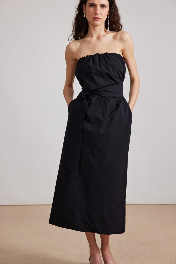 A fitted black strapless maxi dress with a sleek silhouette and elegant design.