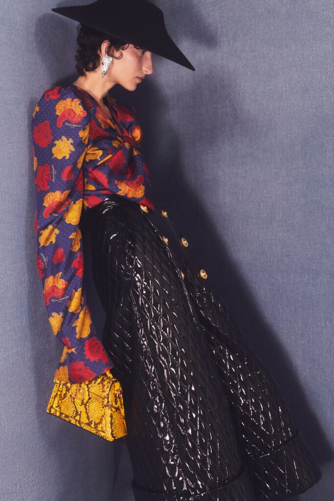 A relaxed fit printed top with long sleeves paired with wide-leg pants in black.