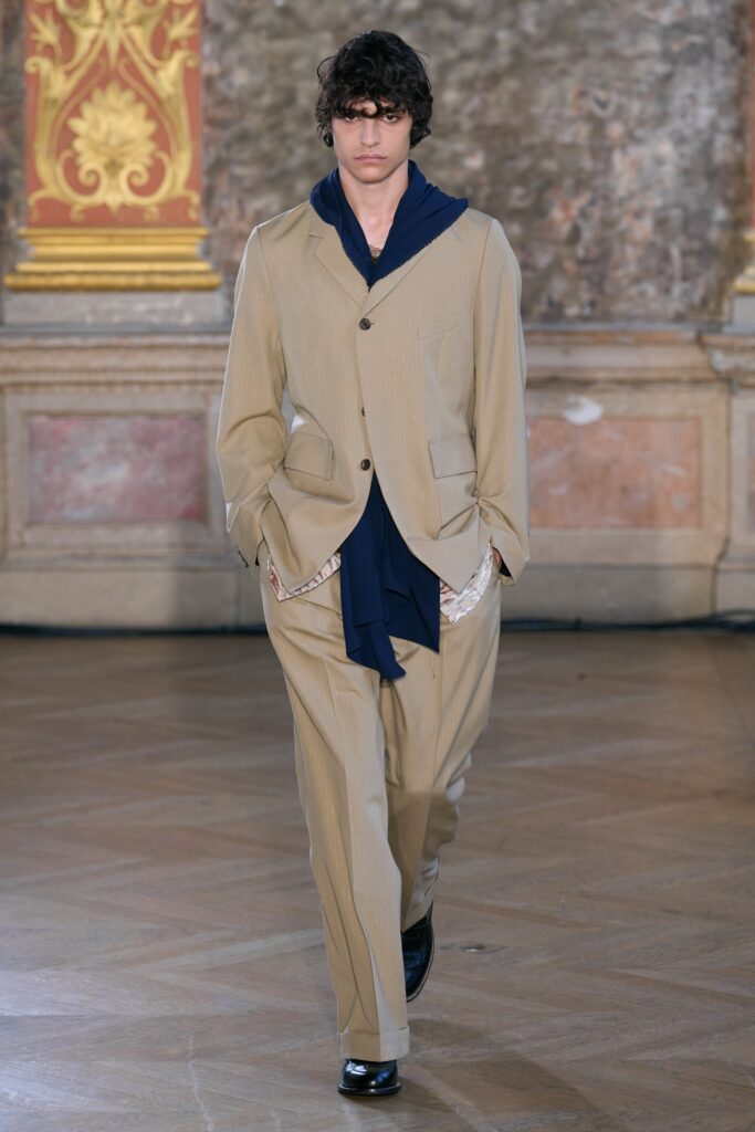 beige tailored suit with navy shirt