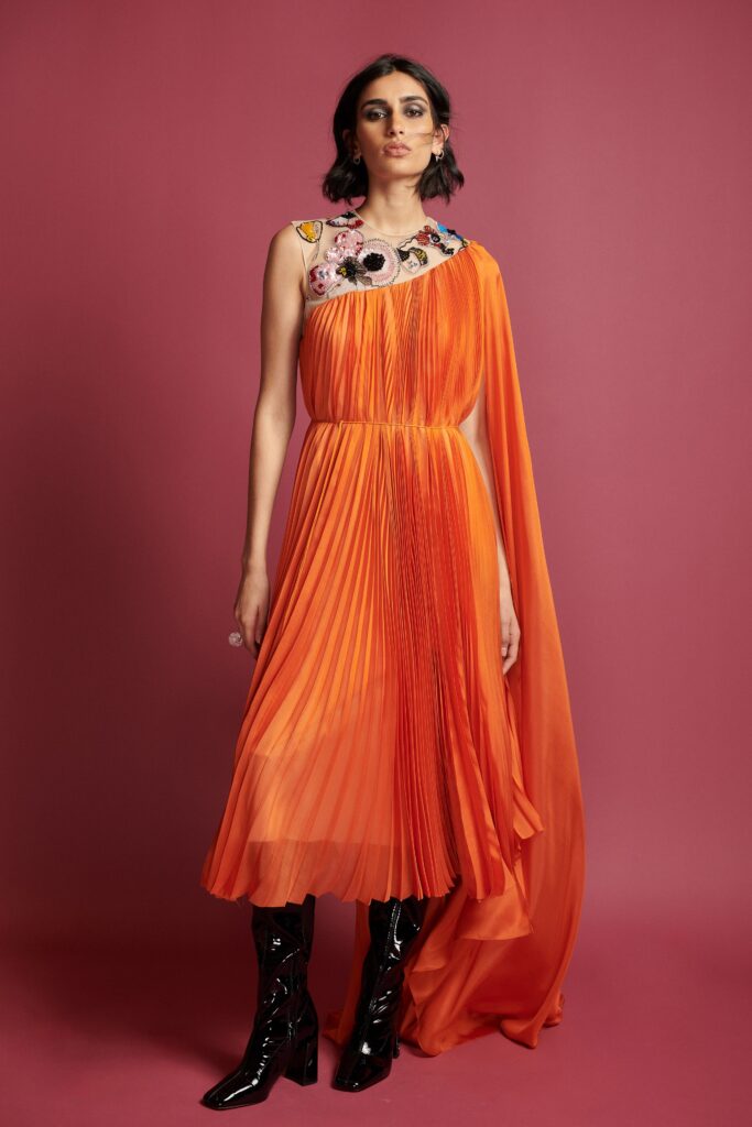 orange pleated midi dress with black boots
