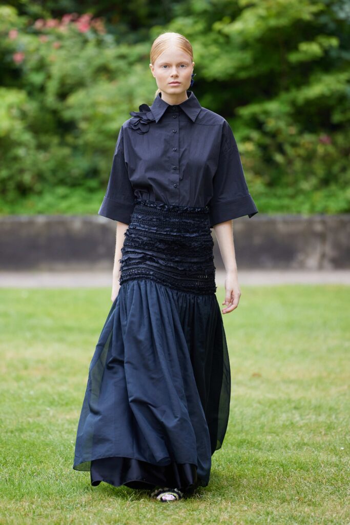 An oversized black dress with pleated detailing and a unique silhouette, perfect for a fashion-forward look.
