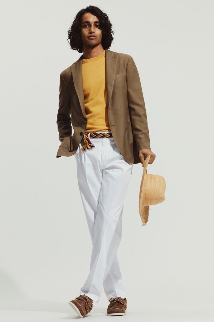 A tailored beige blazer paired with white straight-leg pants and a yellow top.
