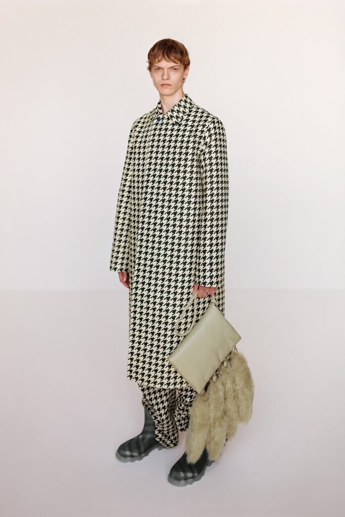 A relaxed-fit black and white checked coat with long sleeves and a collared design.