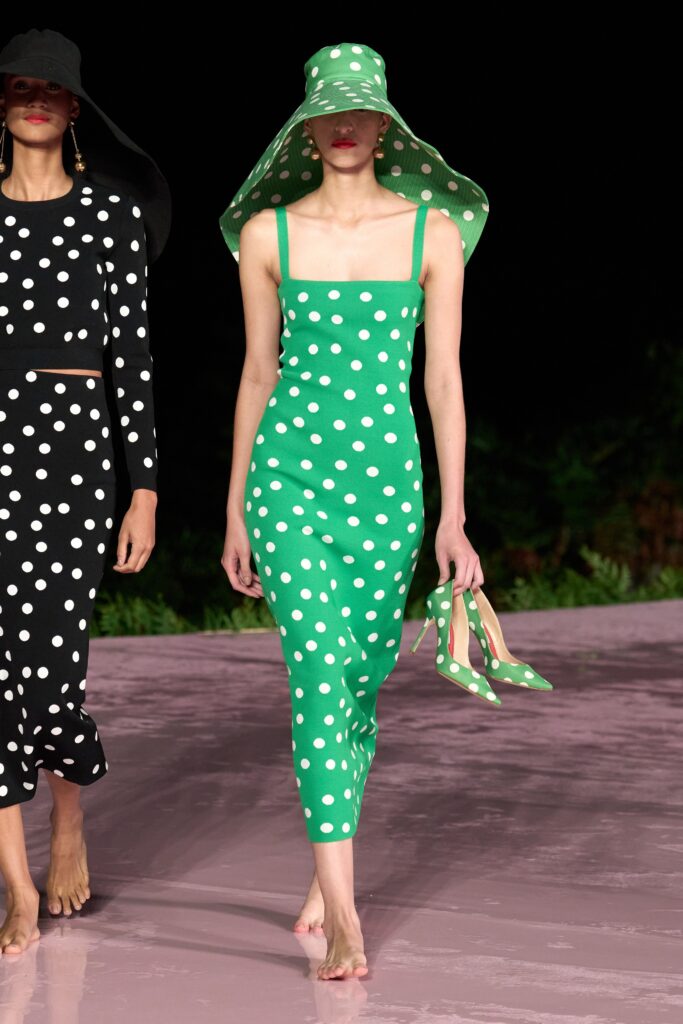A fitted green dress with a square neckline and polka-dot pattern, perfect for summer outings.